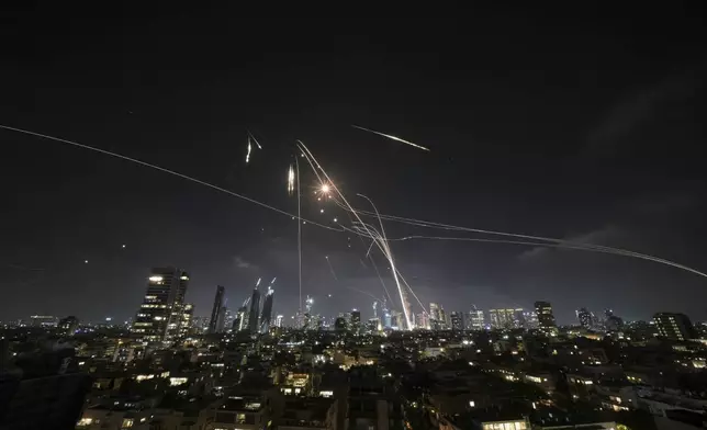 Israeli Iron Dome air defense system fires to intercept missiles over Tel Aviv, Israel, Friday, June 13, 2025. (AP Photo/Leo Correa)