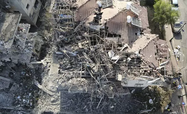 Destroyed residential buildings that was hit by a missile fired from Iran is seen in Ramat Gan, near Tel Aviv, Israel on Saturday, June 14, 2025. (AP Photo/Ariel Schalit)