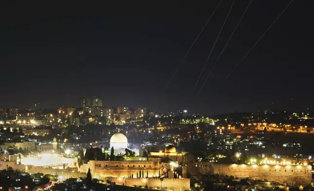 Traces are seen over Jerusalem during a missile attack alert, Friday, June 13, 2025. (AP Photo/Ohad Zwigenberg)
