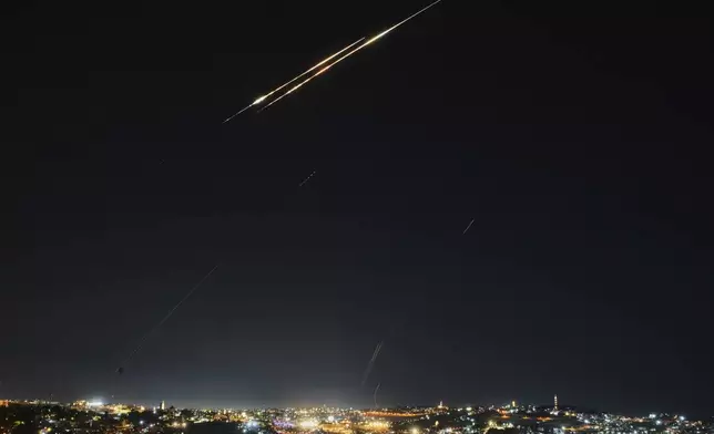 Traces are seen over Jerusalem during a missile attack alert, Friday, June 13, 2025. (AP Photo/Ohad Zwigenberg)