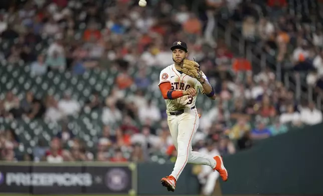 Houston Astros shortstop Jeremy Peña throws to first for an out after fielding a ground ball by Chicago White Sox's Chase Meidroth during the seventh inning of a baseball game Tuesday, June 10, 2025, in Houston. (AP Photo/David J. Phillip)