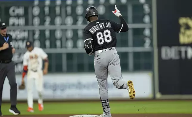Chicago White Sox's Luis Robert Jr. celebrates after hitting a home run against the Houston Astros during the fourth inning of a baseball game Tuesday, June 10, 2025, in Houston. (AP Photo/David J. Phillip)