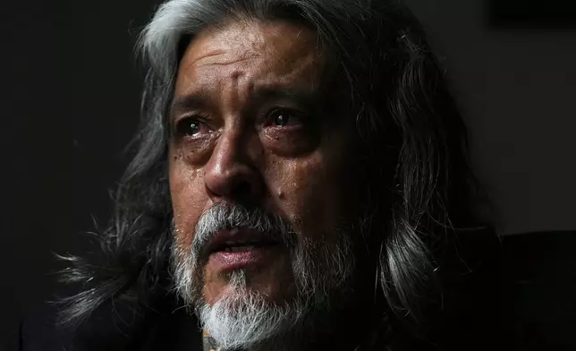 Eduardo Castano sheds tears while thinking about his wife Marité, who died in 2024, unable to secure drugs that had been covered by the federal agency DADSE, which President Javier Milei dissolved, in Buenos Aires, Argentina, Wednesday, April 16, 2025. (AP Photo/Natacha Pisarenko)