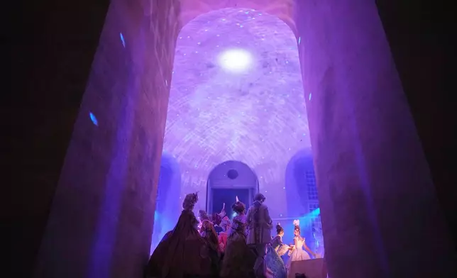 Costumed guests dance at the Great Masked Ball in the Orangerie of the Versailles castle, outside Paris, Sunday, June 22, 2025. (AP Photo/Christophe Ena)