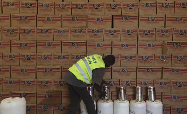 A man arranges USAID humanitarian aid inside a warehouse run by the World Food Programme (WFP) at Kakuma Refugee Camp in Turkana, Kenya Tuesday, June 3, 2025. (AP Photo/Andrew)