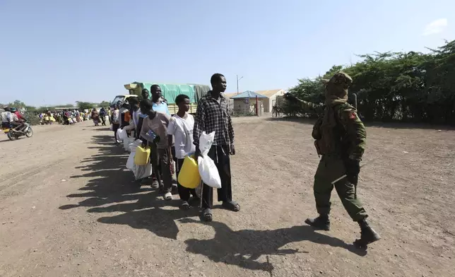 Refugees waiting in a queue to receive humanitarian aid distributed by the World Food Programme (WFP) at Kakuma Refugee Camp in Turkana, Kenya Wednesday, June 4, 2025. (AP Photo/Andrew)