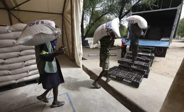 Workers load USAID humanitarian aid into a truck at a World Food Programme (WFP) warehouse in Kakuma Refugee Camp, Turkana, Kenya Tuesday, June 3, 2025. (AP Photo/Andrew Kasuku)