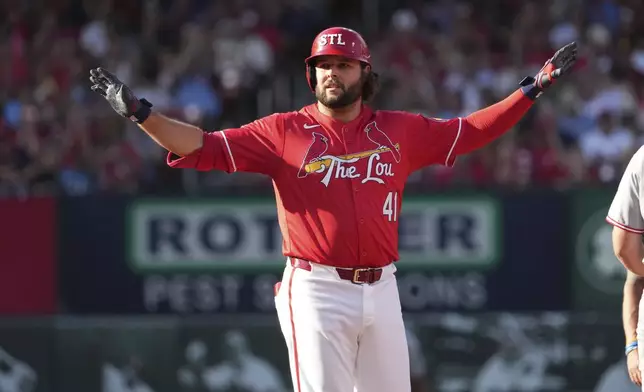 St. Louis Cardinals' Alec Burleson celebrates hitting a double during the first inning of a baseball game against the Cincinnati Reds Friday, June 20, 2025, in St. Louis. (AP Photo/Jeff Roberson)