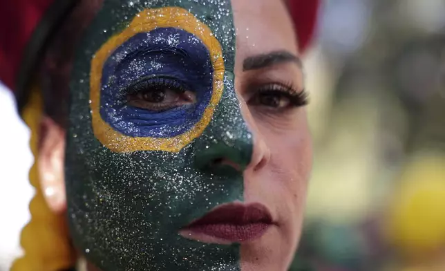 A supporter of former President Jair Bolsonaro attends a protest against his Supreme Court trial, in which he is accused of involvement in a 2022 coup attempt, in Sao Paulo, Sunday, June, 29, 2025. (AP Photo/Ettore Chiereguini)