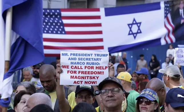 Supporters of former President Jair Bolsonaro protest his Supreme Court trial, in which he is accused of involvement in a 2022 coup attempt, in front of an American and an Israeli flag, in Sao Paulo, Sunday, June, 29, 2025. (AP Photo/Ettore Chiereguini)