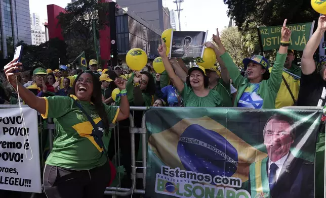 Supporters of former President Jair Bolsonaro protest his Supreme Court trial, in which he is accused of involvement in a 2022 coup attempt, in Sao Paulo, Sunday, June, 29, 2025. (AP Photo/Ettore Chiereguini)