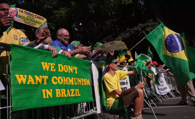 Supporters of former President Jair Bolsonaro protest his Supreme Court trial, in which he is accused of involvement in a 2022 coup attempt, in Sao Paulo, Sunday, June, 29, 2025. (AP Photo/Ettore Chiereguini)