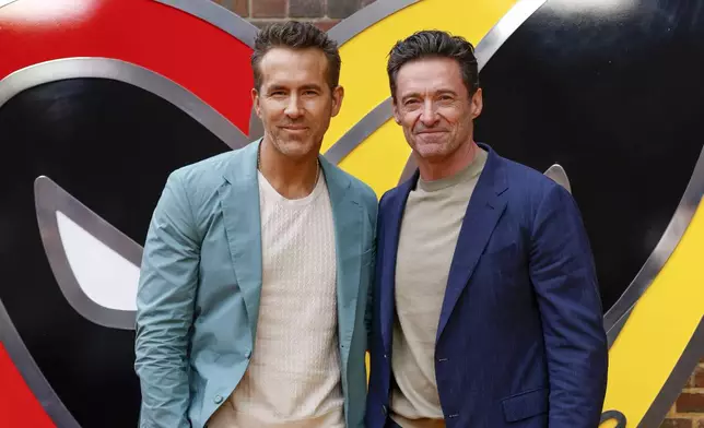 FILE - Ryan Reynolds, left, and Hugh Jackman pose for photographers upon arrival at the screening of the film "Deadpool &amp; Wolverine" on July 11, 2024 in London. (Photo by Millie Turner/Invision/AP, File)