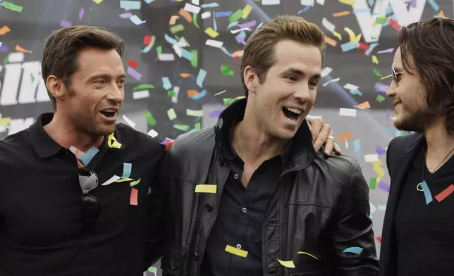 FILE - Actors Hugh Jackman, left, Ryan Reynolds, center, and Taylor Kitsch chat as the confetti flies at the world premiere of "X-Men Origins: Wolverine", April 27, 2009, in Tempe, Ariz. (AP Photo/Ross D. Franklin, File)