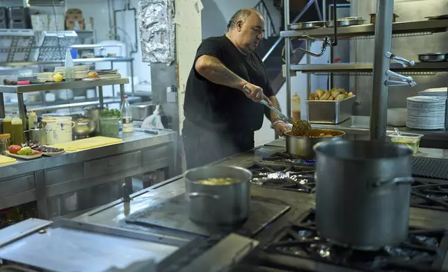 A chef cooks at Casa Pedro restaurant in Madrid, Spain, on May 16, 2025. (AP Photo/Manu Fernandez)