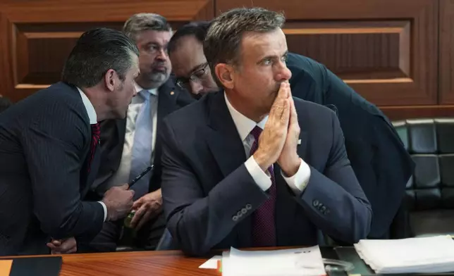 This image provided by the White House shows CIA Director John Ratcliffe, in foreground seated, as Defense Secretary Pete Hegseth, left, speaks with national security adviser Andy Baker with White House counsel David Warrington seated in background in the Situation Room, Saturday, June 21, 2025, at the White House in Washington. (The White House via AP)
