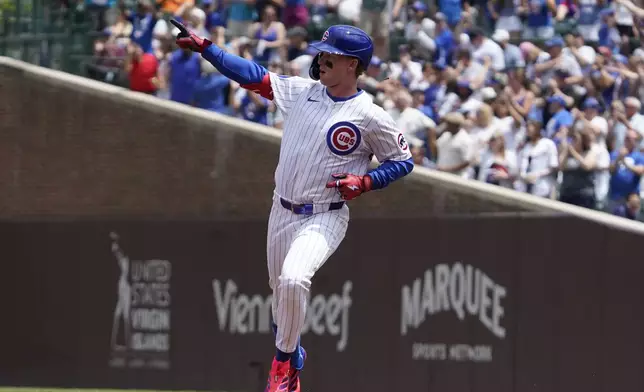 Chicago Cubs' Pete Crow-Armstrong gestures after hitting a two-run home run against the Milwaukee Brewers during the first inning of a baseball game Thursday, June 19, 2025, in Chicago. (AP Photo/David Banks)