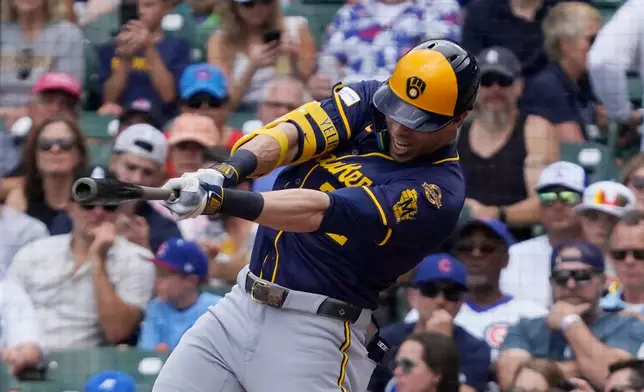 Milwaukee Brewers' Christian Yelich hits a one-run single during the first inning of a baseball game against the Chicago Cubs, Thursday, June 19, 2025, in Chicago. (AP Photo/David Banks)
