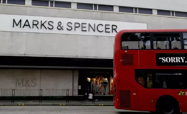FILE - A bus passes a branch of Marks and Spencer in London, Tuesday, Aug. 18, 2020. (AP Photo/Kirsty Wigglesworth, file)