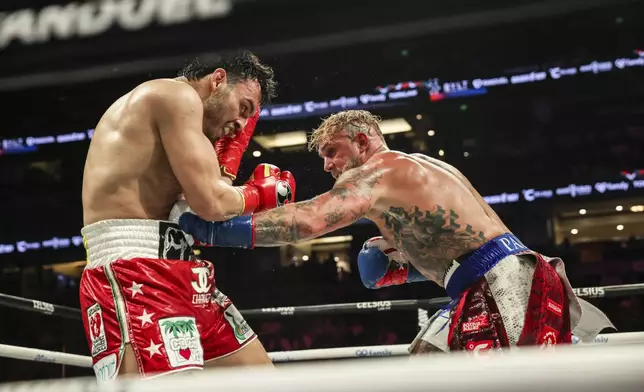 Jake Paul, right, punches Julio Cesar Chavez Jr. during their cruiserweight boxing match on Saturday, June 28, 2025, in Anaheim, Calif. (AP Photo/Etienne Laurent)