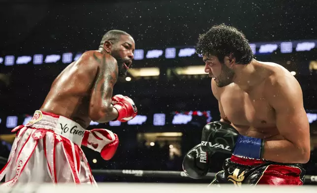 Gilberto Ramirez, right, looks at Yuniel Dorticos during their WBA and WBO cruiserweight titles boxing match on Saturday, June 28, 2025, in Anaheim, Calif. (AP Photo/Etienne Laurent)
