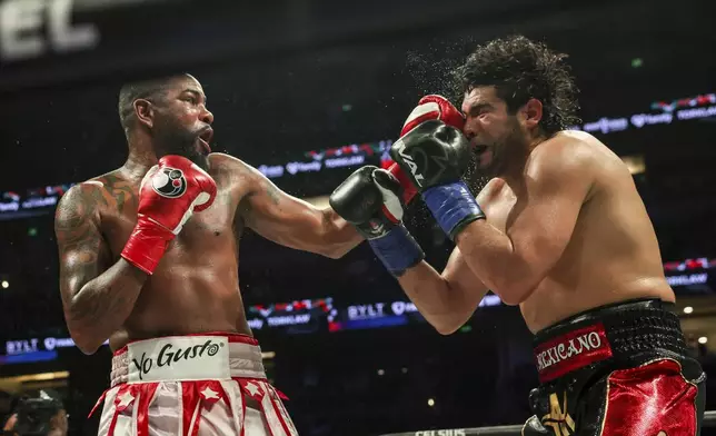Yuniel Dorticos, left, punches Gilberto Ramirez during their WBA and WBO cruiserweight titles boxing match on Saturday, June 28, 2025, in Anaheim, Calif. (AP Photo/Etienne Laurent)