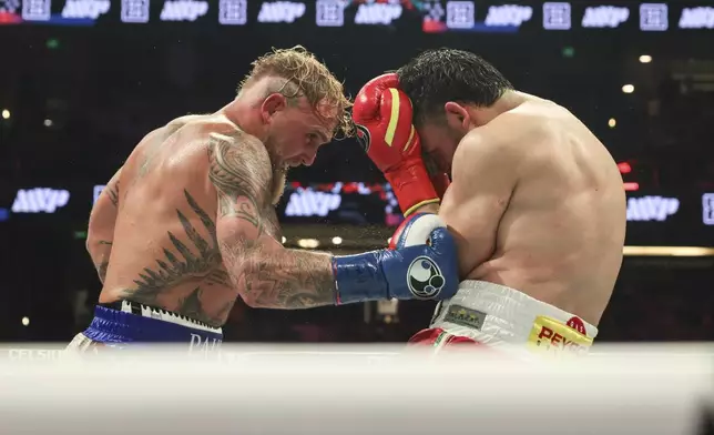 Jake Paul, left, punches Julio Cesar Chavez Jr. during their cruiserweight boxing match on Saturday, June 28, 2025, in Anaheim, Calif. (AP Photo/Etienne Laurent)