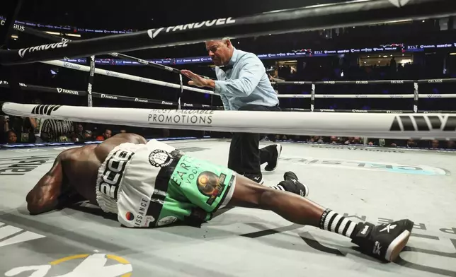 Avious Griffin lays on the apron after being knocked out by Julian Rodriguez during their WBC USA &amp; WBA Continental America Welterweight title boxing match on Saturday, June 28, 2025, in Anaheim, Calif. (AP Photo/Etienne Laurent)