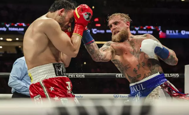 Jake Paul, right, punches Julio Cesar Chavez Jr. during their cruiserweight boxing match on Saturday, June 28, 2025, in Anaheim, Calif. (AP Photo/Etienne Laurent)