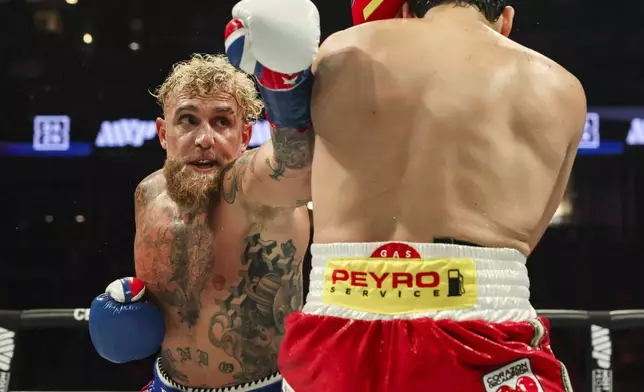 Jake Paul, left, punches Julio Cesar Chavez Jr. during their cruiserweight boxing match on Saturday, June 28, 2025, in Anaheim, Calif. (AP Photo/Etienne Laurent)