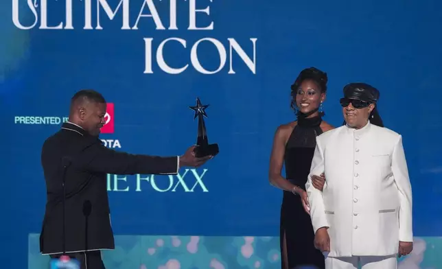 Jamie Foxx accepts the ultimate icon award during the BET Awards on Monday, June 9, 2025, at the Peacock Theater in Los Angeles. Stevie Wonder looks on from right.(AP Photo/Chris Pizzello)