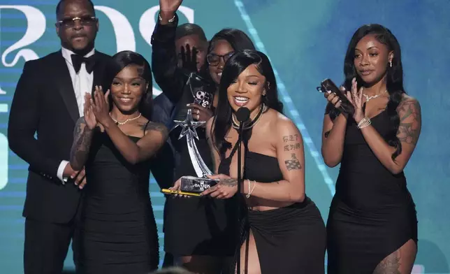 GloRilla, center, accepts the award for Dr. BobbyJones best gospel/inspirational award for "Rain Down on Me" during the BET Awards on Monday, June 9, 2025, at the Peacock Theater in Los Angeles. (AP Photo/Chris Pizzello)
