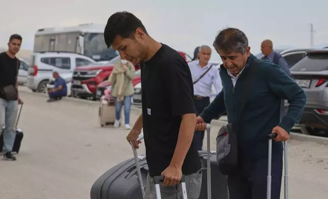 Iranians arrive to cross into Iran at Gurbulak Bazargan border post, in Gurbulak, Turkey, Monday, June 16, 2025. (AP Photo/Kadir Cesur)