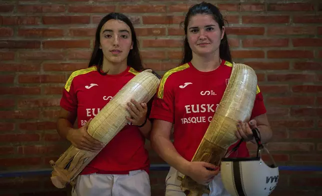 Arai Lejardi, left, and Erika Mugartegui, members of the Spanish national team, pose for a photo ahead of the Nations League match between the Euskadi national team and the Spanish national team at the Jai Alai fronton in Guernica-Luno, northern Spain, Friday, June 6, 2025. (AP Photo/Miguel Oses)