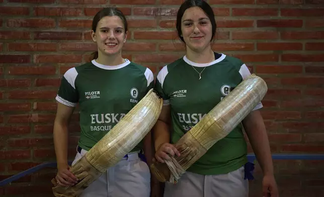 Elaia Gogenola, left, and Maia Goikoetxea, members of the Euskadi national team, pose for a photo ahead of the Nations League match between the Euskadi national team and the Spanish national team at the Jai Alai fronton in Guernica-Luno, northern Spain, Friday, June 6, 2025. (AP Photo/Miguel Oses)