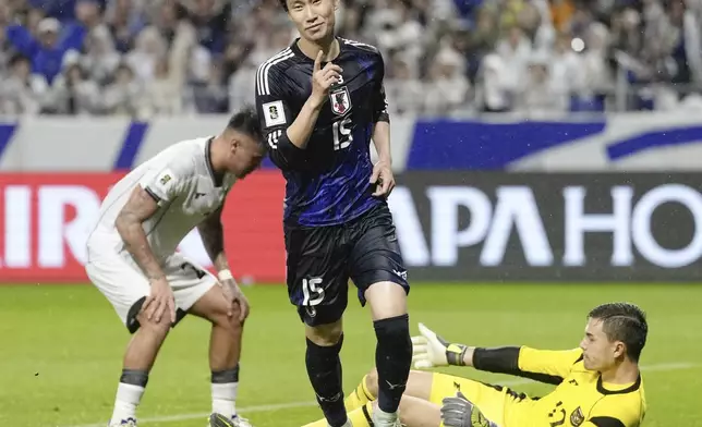 Japan's Daichi Kamada, center, celebrates after scoring his side's second goal during the World Cup 2026 group C qualifying soccer match between Japan and Indonesia in Suita, Japan, Tuesday, June 10, 2025. (Shohei Miyano/Kyodo News via AP)