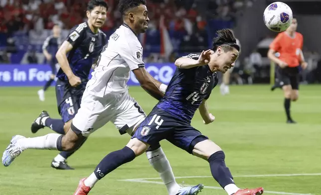Japan's Shunsuke Mito, right, and Indonesia's Yakob Sayuri, left, compete the ball during the World Cup 2026 group C qualifying soccer match in Suita, west Japan, Tuesday, June 10, 2025. (Yu Matsuda/Kyodo News via AP)