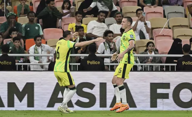 Australia's Mitchell Duke, right, celebrates after scoring his side's second goal during the World Cup 2026 Group C qualifying soccer match between Saudi Arabia and Australia at King Abdullah Stadium in Jeddah, Saudi Arabia, Tuesday, June 10, 2025. (AP Photo)