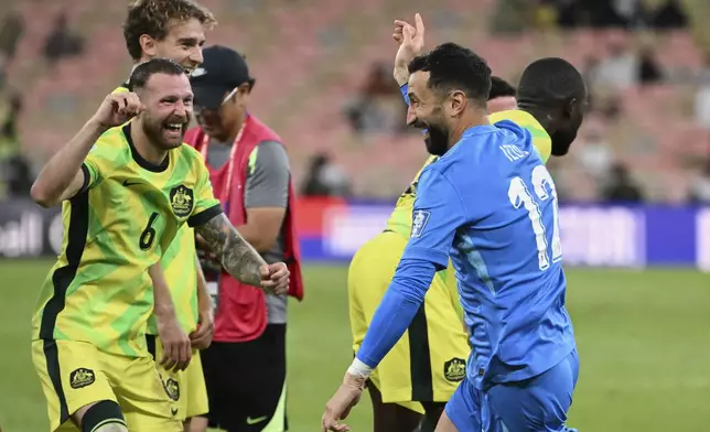 Australia's Martin Boyle, left, an dAustralia's goalkeeper Paul David Izzo celebrate after winning a World Cup 2026 Group C qualifying soccer match against Saudi Arabia at King Abdullah Stadium in Jeddah, Saudi Arabia, Tuesday, June 10, 2025. (AP Photo)