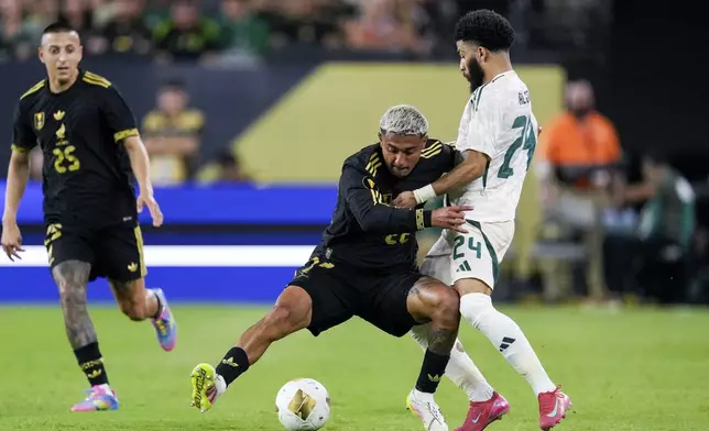 Mexico defender Julián Araujo (22) and Saudi Arabia forward Abdulrahman Alobud (24) battle for the ball during a CONCACAF Gold Cup quarterfinal soccer match, Saturday, June 28, 2025, in Glendale, Ariz. (AP Photo/Samantha Chow)