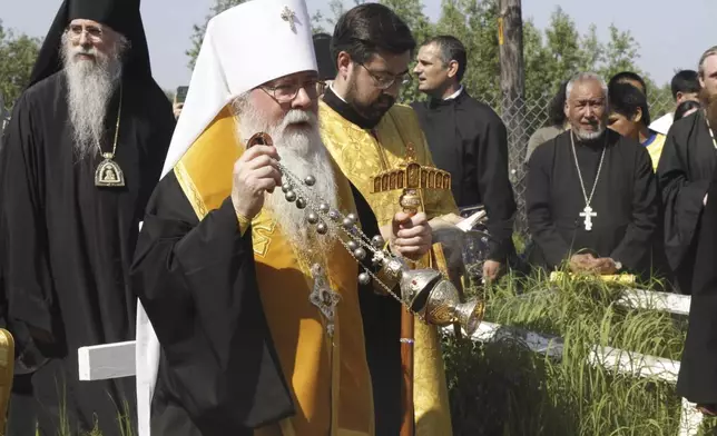 Metropolitan Tikhon, the head of the Orthodox Church in America, swings a censer as he blesses the remains of Matushka Olga Michael before a ceremony that made her the first female Orthodox saint in North America, in Kwethluk, Alaska, on June 19, 2025. (AP Photo/Mark Thiessen)