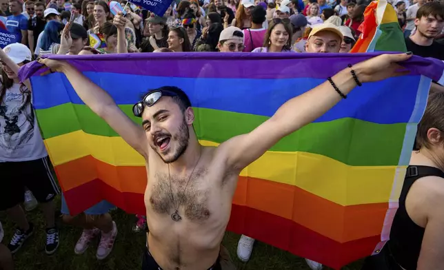 Yamal dances while holding a rainbow flag during the Bucharest Pride Parade, in Bucharest, Romania, Saturday, June 7, 2025. (AP Photo/Andreea Alexandru)