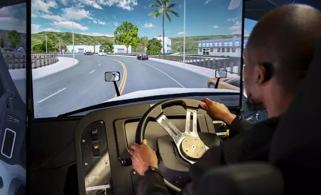 Mohammed Kamal practices handling a tractor-trailer truck in a driving simulator at the Driving Academy on Tuesday, June 10, 2025 in Linden, N.J. (AP Photo/Angelina Katsanis)