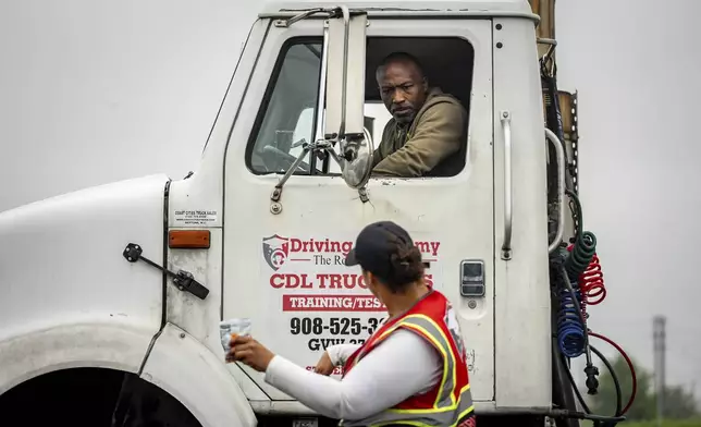 An instructor provides reverse parking advice to a student at the Driving Academy on Tuesday, June 10, 2025 in Linden, N.J., where students prepare to obtain a Commercial Driver’s License (CDL) with multilingual instructors.(AP Photo/Angelina Katsanis)