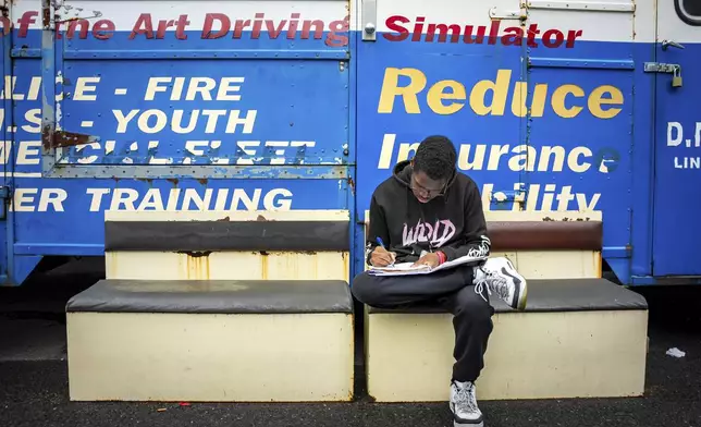 Solane Ellis studies at the Driving Academy on Tuesday, June 10, 2025 in Linden, N.J., where students prepare to obtain a Commercial Driver’s License (CDL) with multilingual instructors. (AP Photo/Angelina Katsanis)