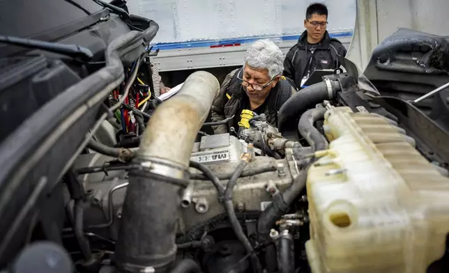 A student studies a truck engine at the Driving Academy on Tuesday, June 10, 2025 in Linden, N.J., where students prepare to obtain a Commercial Driver’s License (CDL) with multilingual instructors. (AP Photo/Angelina Katsanis)
