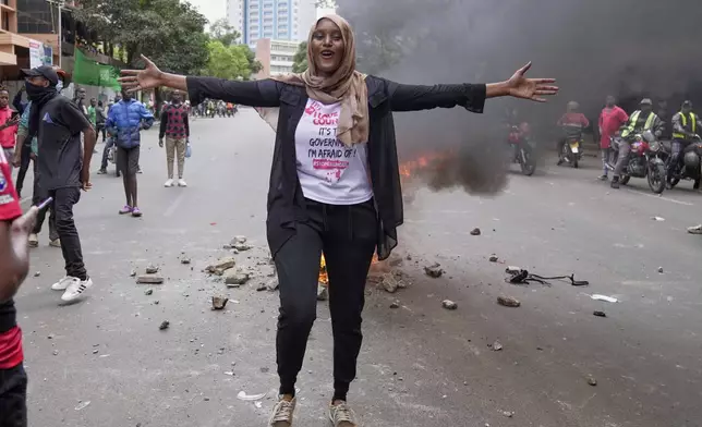 Kenyan activist Hanifa gestures during a demonstration over the death of blogger Albert Ojwang in police custody, in downtown Nairobi, Kenya, Tuesday, June 17, 2025. (AP Photo/Brian Inganga)