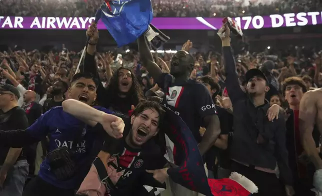 PSG supporters celebrate during the Champions League final soccer match between Paris Saint-Germain and Inter Milan, Saturday, May 31, 2025 at the Parc des Princes stadium in Paris. (AP Photo/Michel Euler)