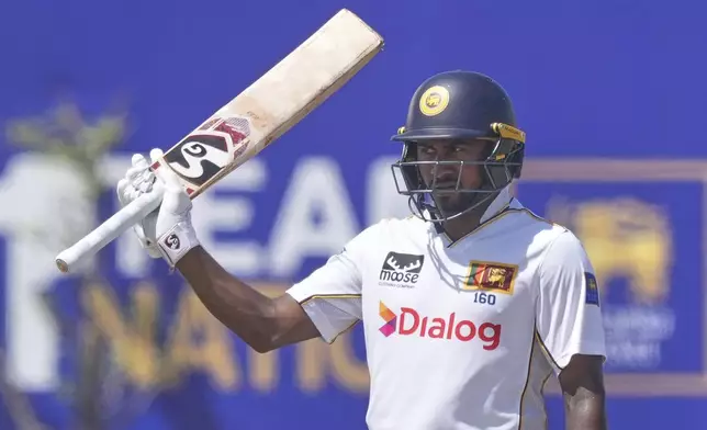 Sri Lanka's Kamindu Mendis celebrates his fifty runs during day four of the first cricket test match between Sri Lanka and Bangladesh in Galle, Sri Lanka, Friday, June 20, 2025. (AP Photo/Eranga Jayawardena)