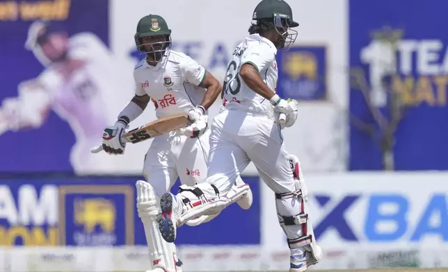 Bangladesh's Shadman Islam, left, and Anamul Haque run between the wickets during day four of the first cricket test match between Sri Lanka and Bangladesh in Galle, Sri Lanka, Friday, June 20, 2025. (AP Photo/Eranga Jayawardena)